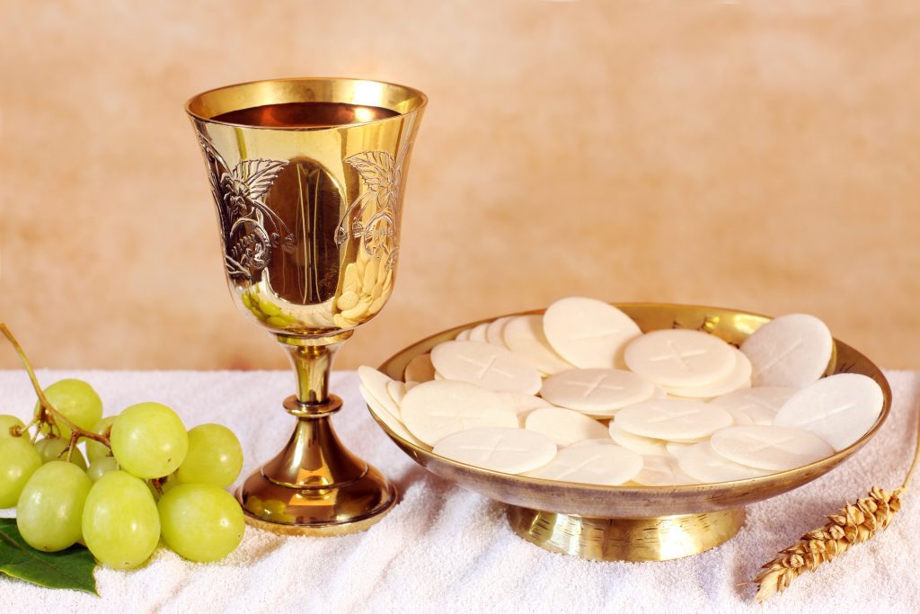 Chalice of wine and a platter with the Communion